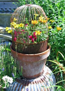 Vintage birdcage in a flower pot