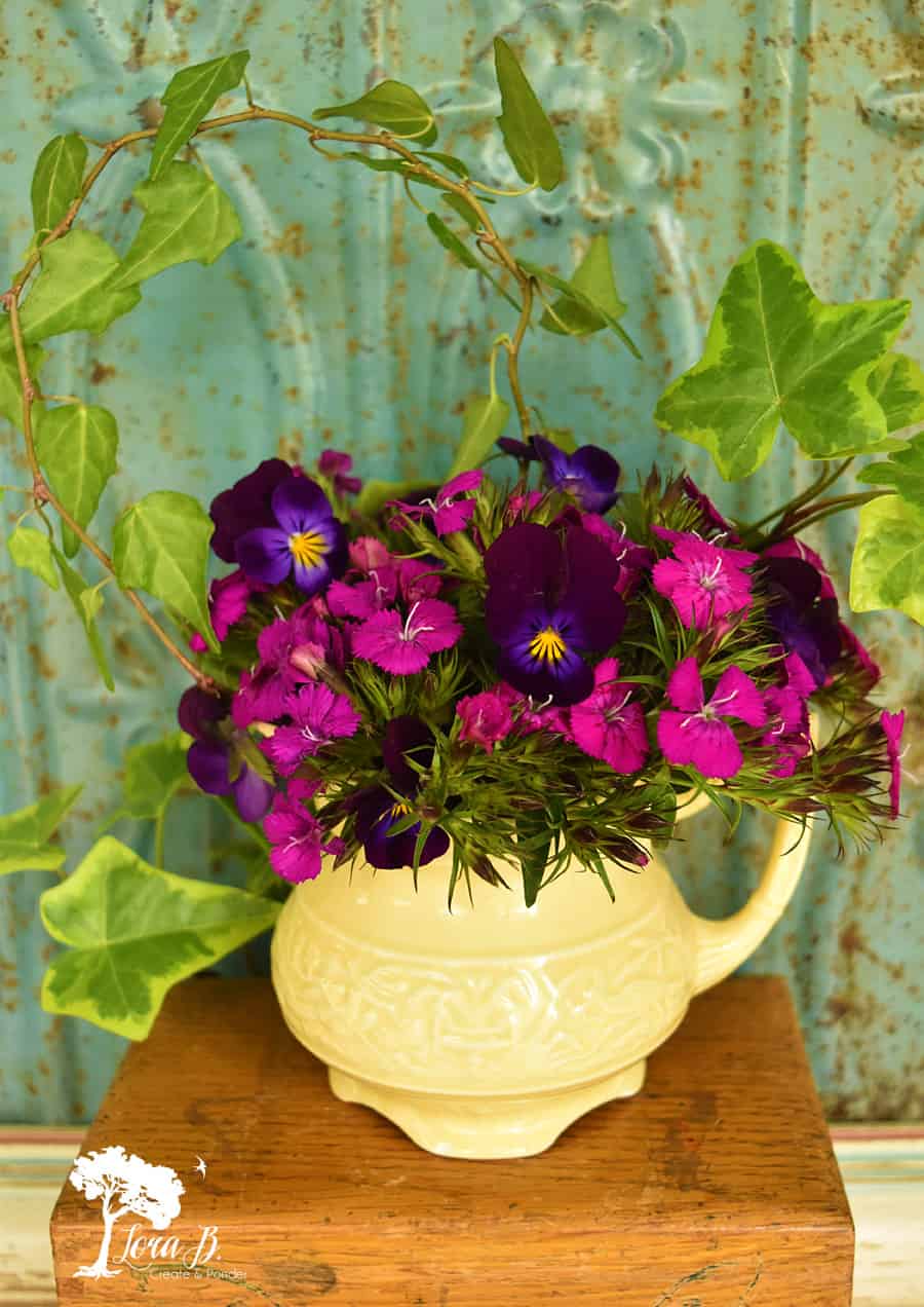 Purple wild violets in a yellow pitcher.