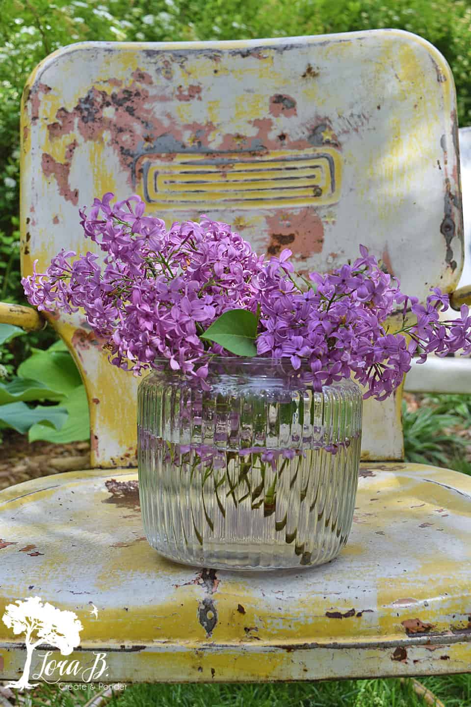 Lilacs on a vintage lawn chair.