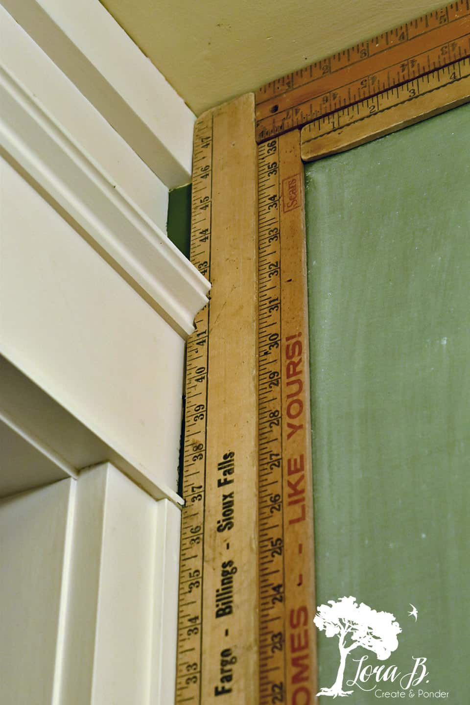 Rulers become a frame for a chalkboard wall.