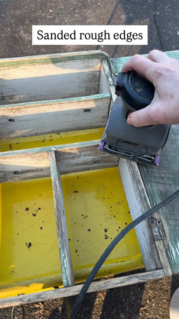Sanding rough edges with palm sander.