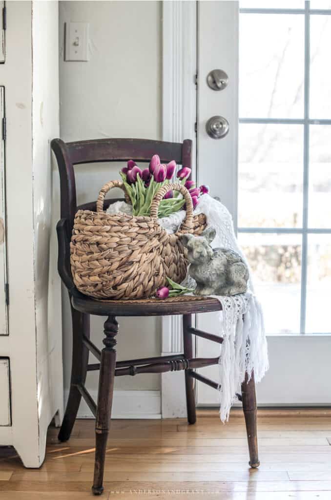 Old chair with tulips in basket