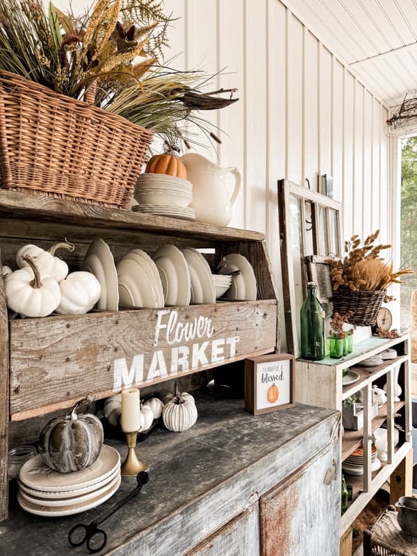 White fall decorations on rustic cupboard