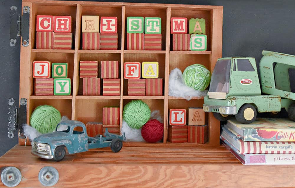 Divided wood crate with old blocks for Christmas.