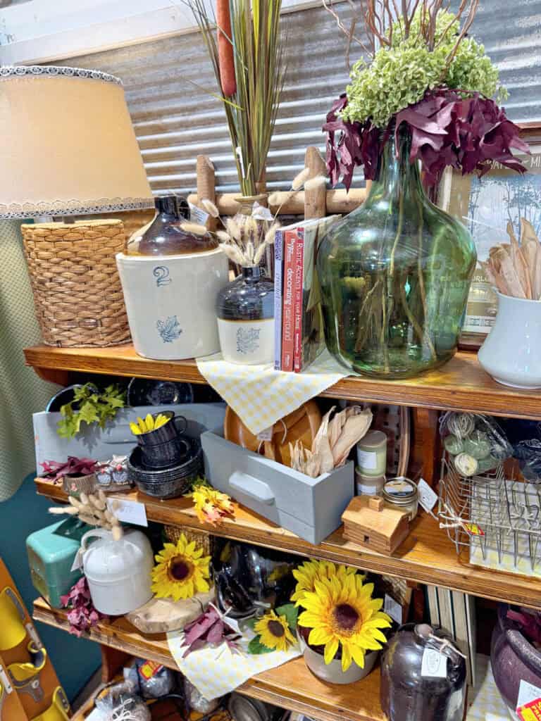 Wooden shelves in antique booth filled with fall decor.