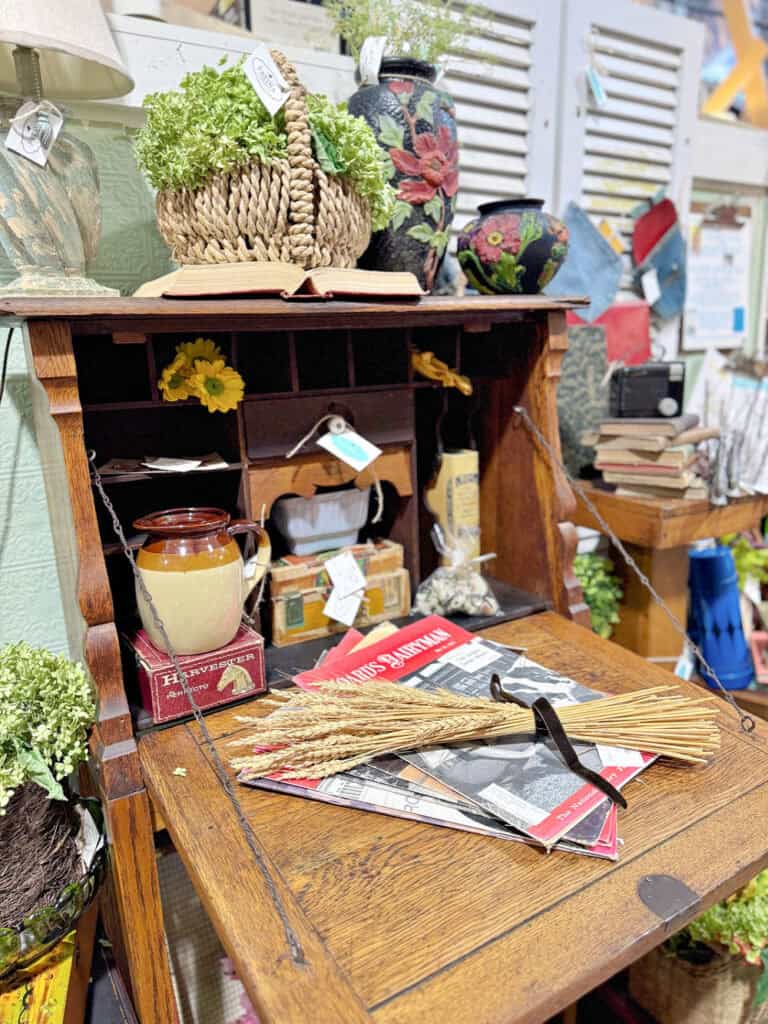 Antique desk with cubbies displayed in antique booth for fall.