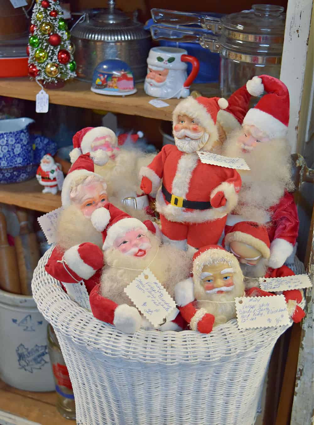 Vintage santas in wicker basket.