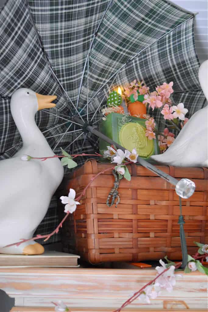 Green plaid umbrella and picnic basket with duck.