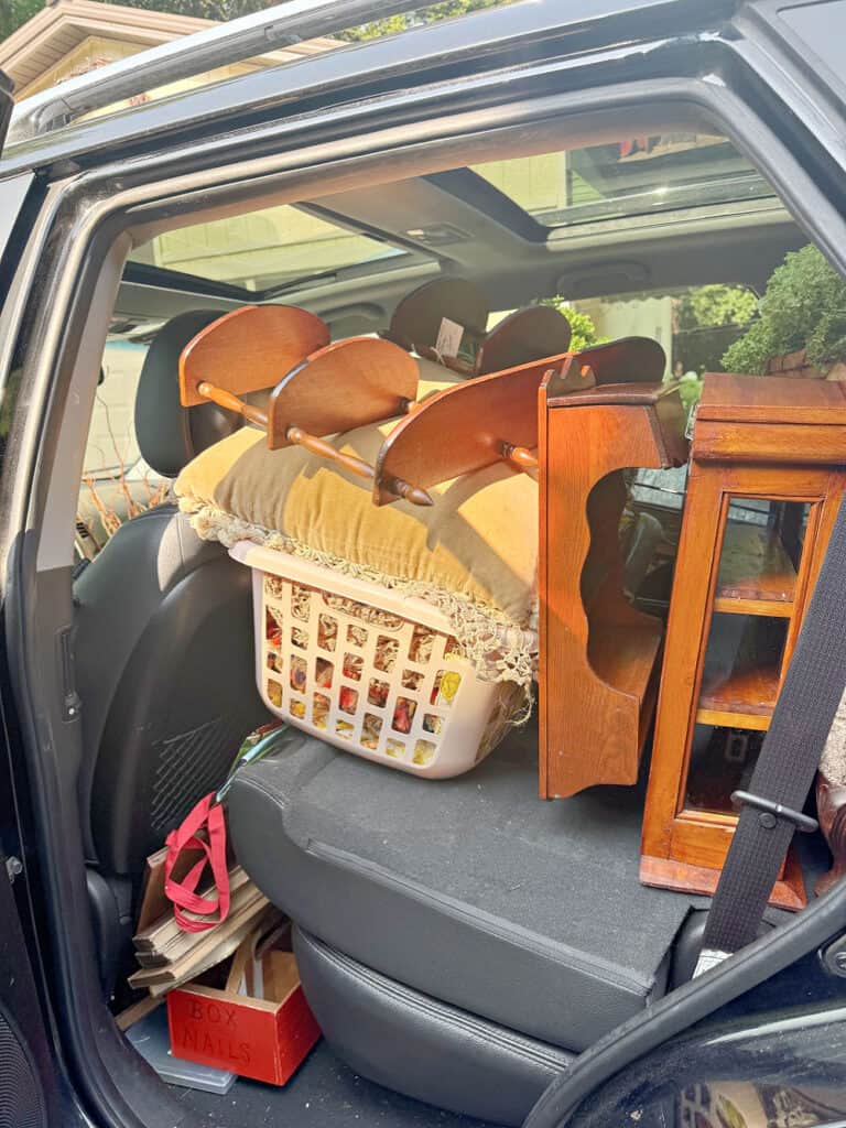 Wood shelves and laundry basket in car for vintage booth restocking.