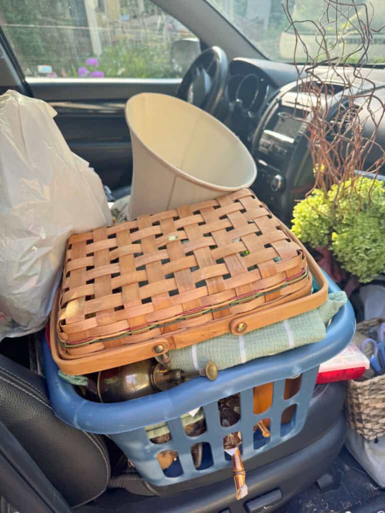 Laundry basket in car filled with vintage finds.