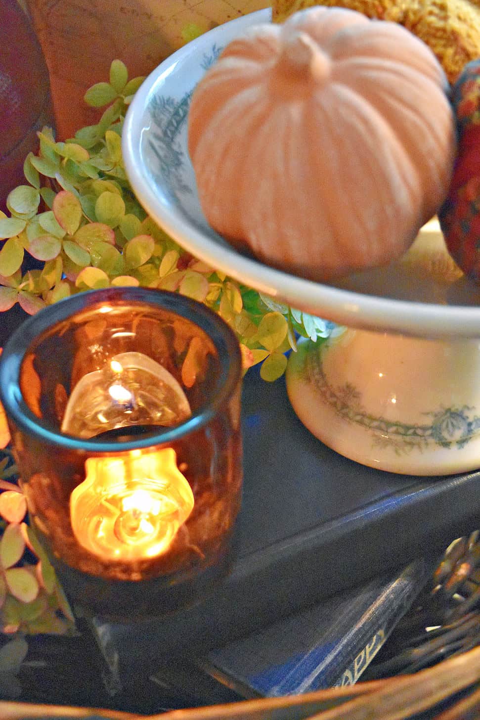 Amber glass candle and ironstone pedestal.