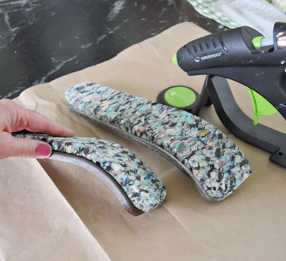 Carpet pad as cushioning on chair arms.