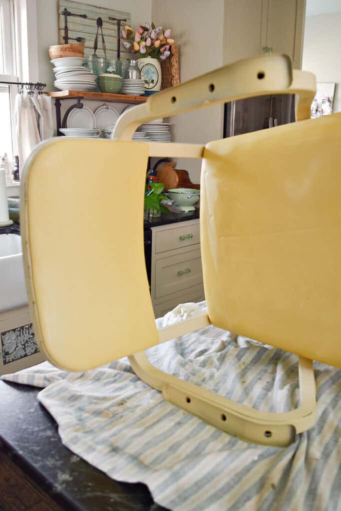 Vintage metal chair with yellow vinyl.
