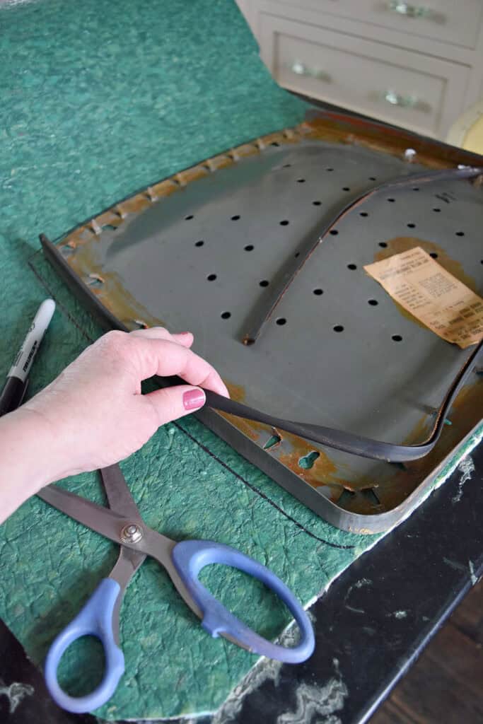 Carpet pad as cushioning on revived old metal chair.