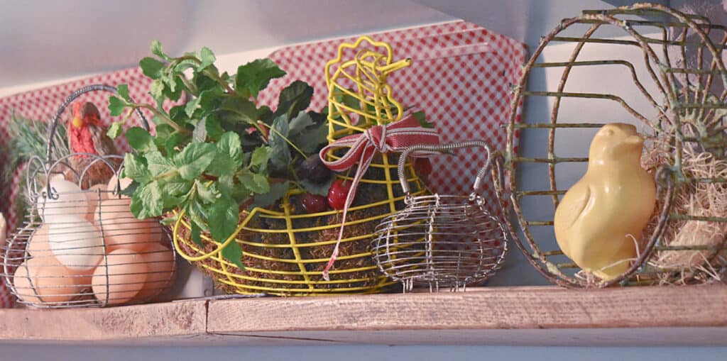 Vintage egg gathering baskets on shelf display.