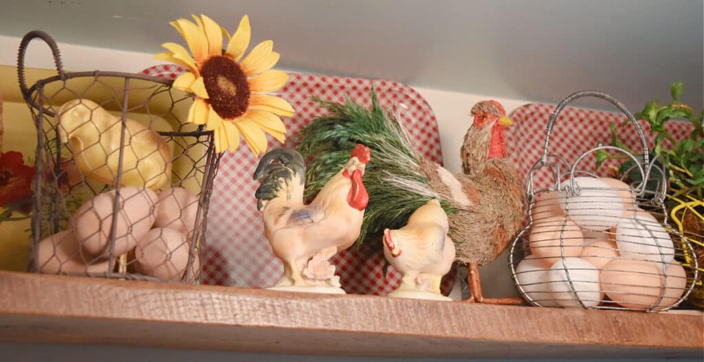 Chicken themed vintage collection items on shelf display.