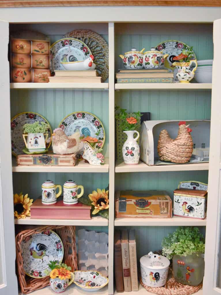 Rooster and chicken themed vintage dishes in kitchen display.