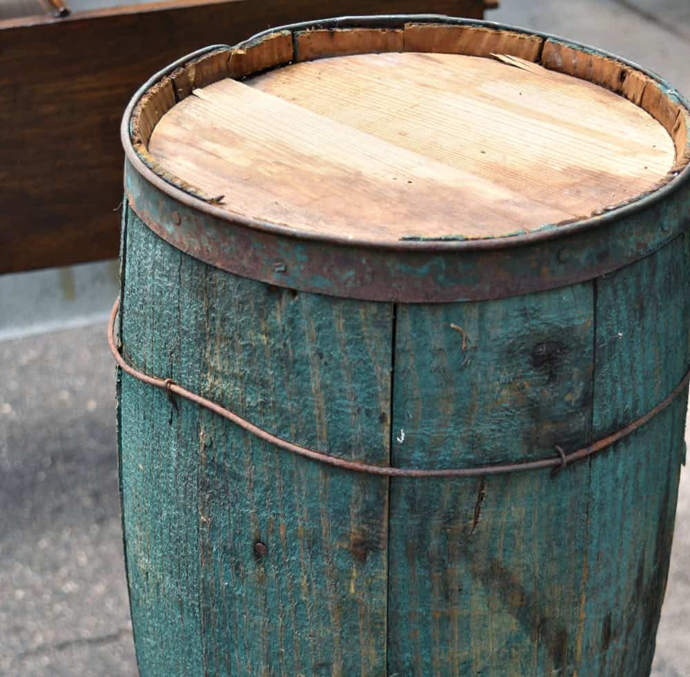 Vintage wooden barrel painted with aqua chippy paint.