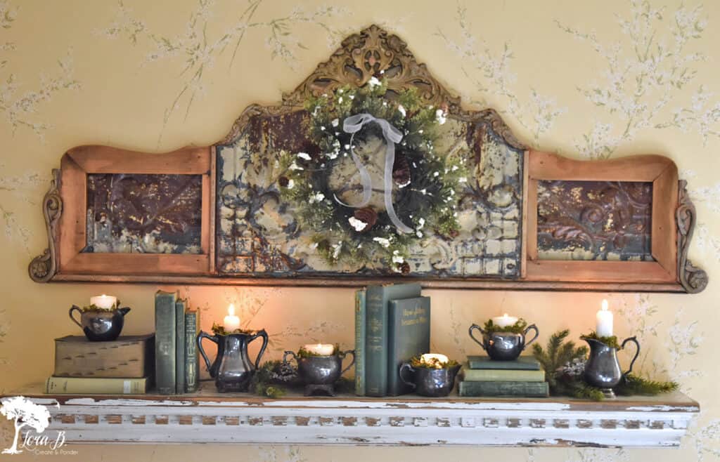 Vintage silver pieces and old books are a pretty shelf display in a vintage Christmas decorated bedroom