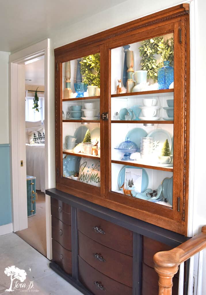 Built in cupboard displaying a collection of winter decor