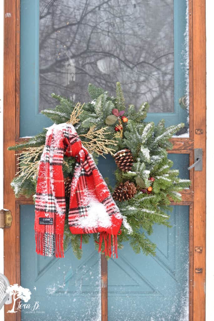 Red plaid scarf decorating Christmas wreath.