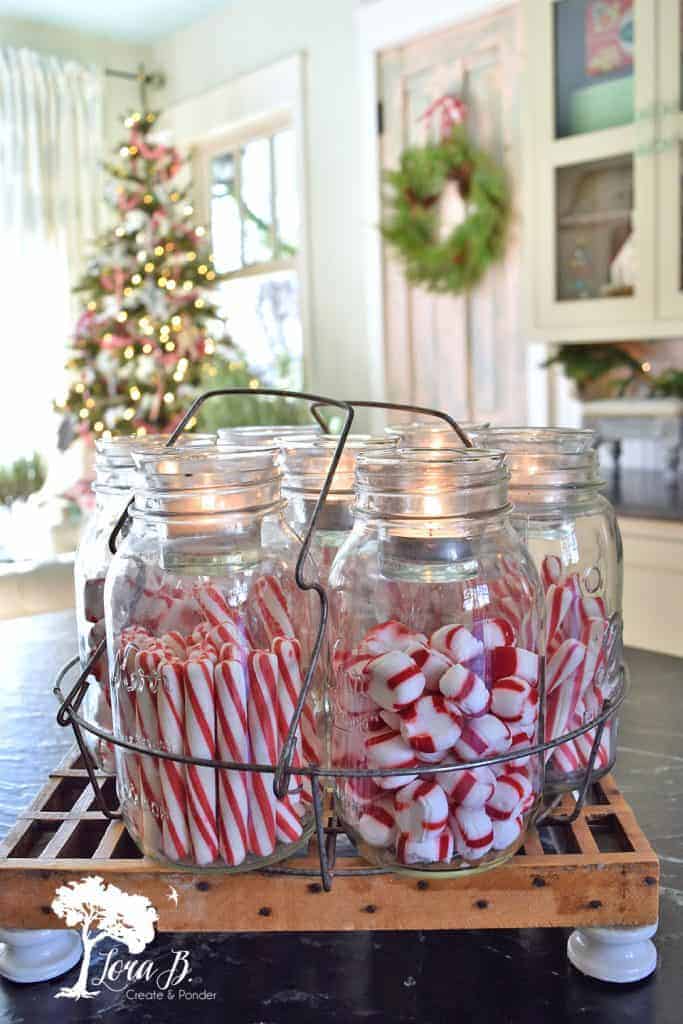 Candy canes in mason jars with candles.