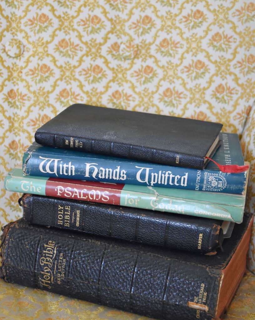 Stack of vintage Bibles and old Christian books.