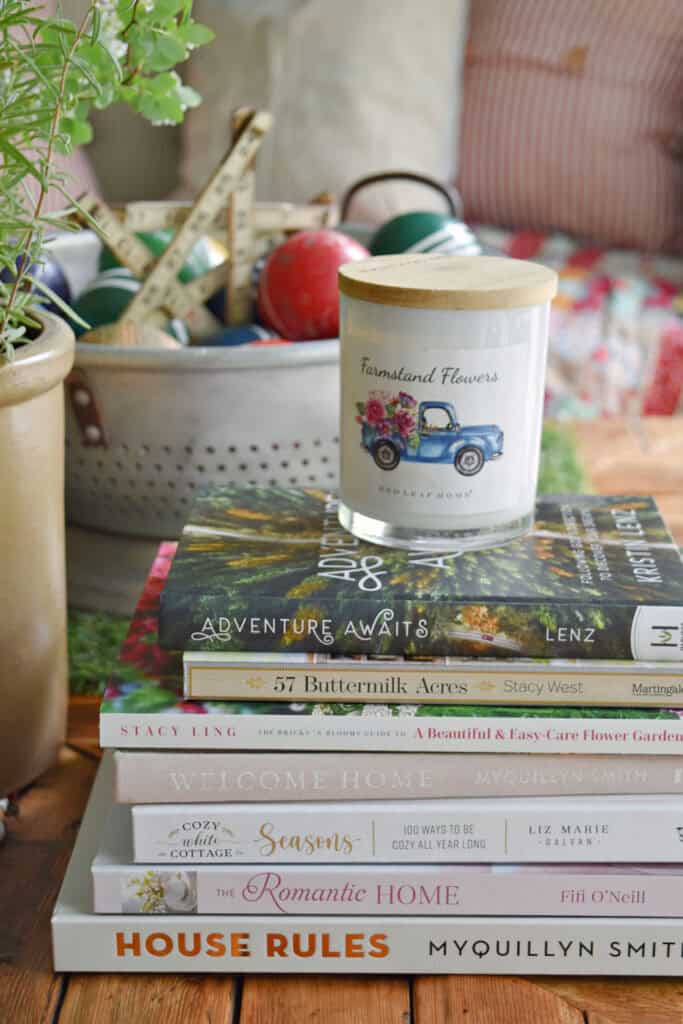 A stack of books with a candle sitting on top.