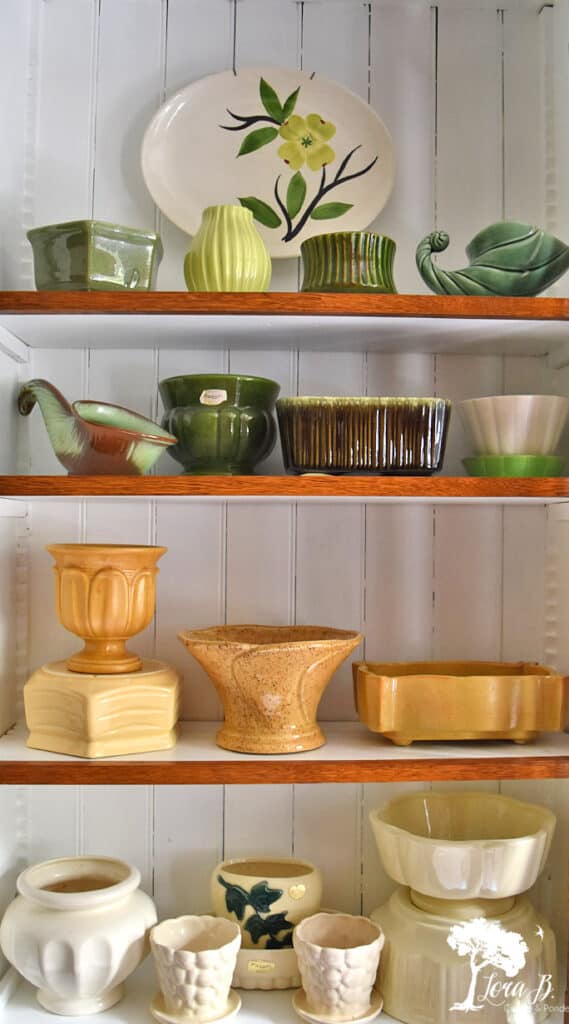 Vintage pottery collection creatively displayed by color.