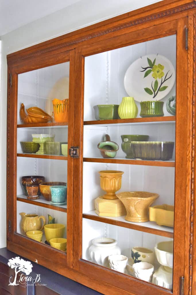 Built in cupboard displaying a collection of vintage pottery