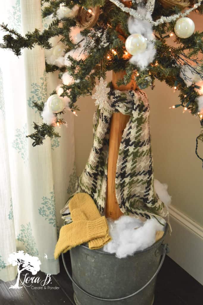 Vintage scarf tied to Christmas tree trunk as decor.