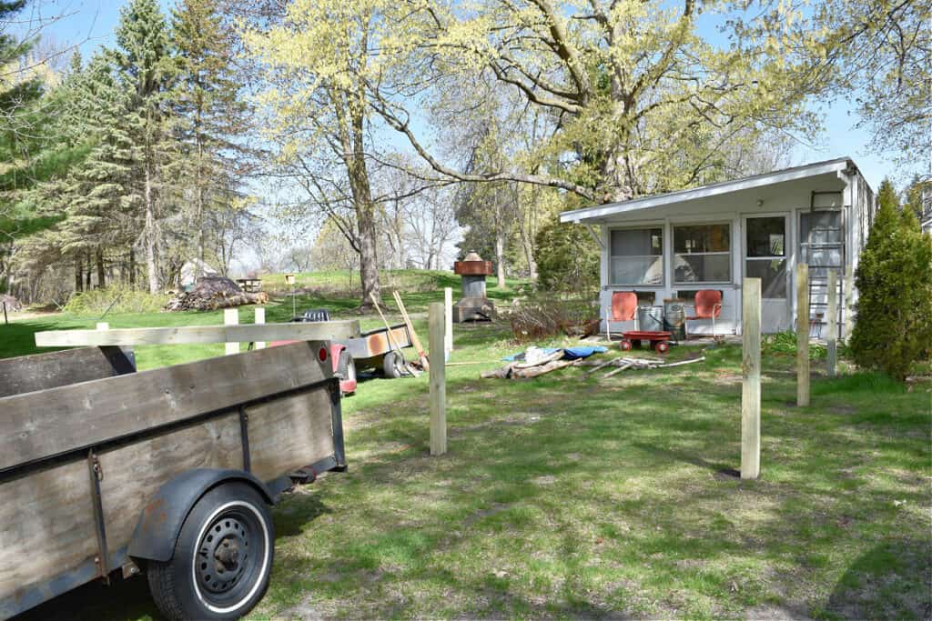 Putting posts in for a picket fence garden.