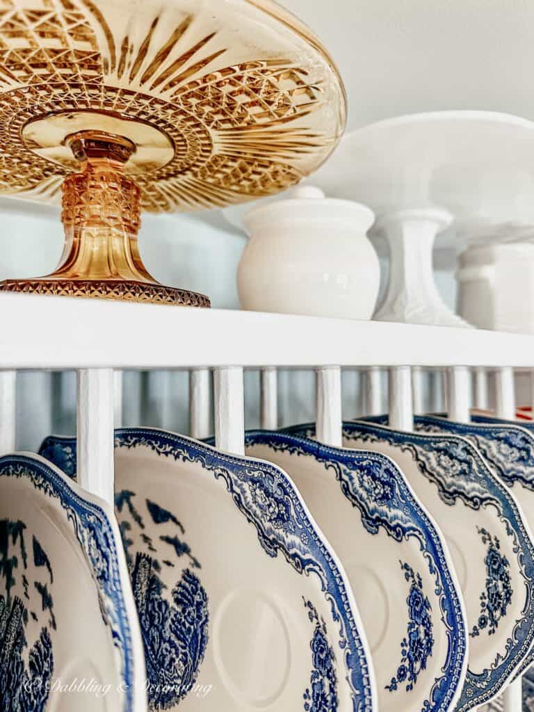 Blue and white dishes in plate rack.