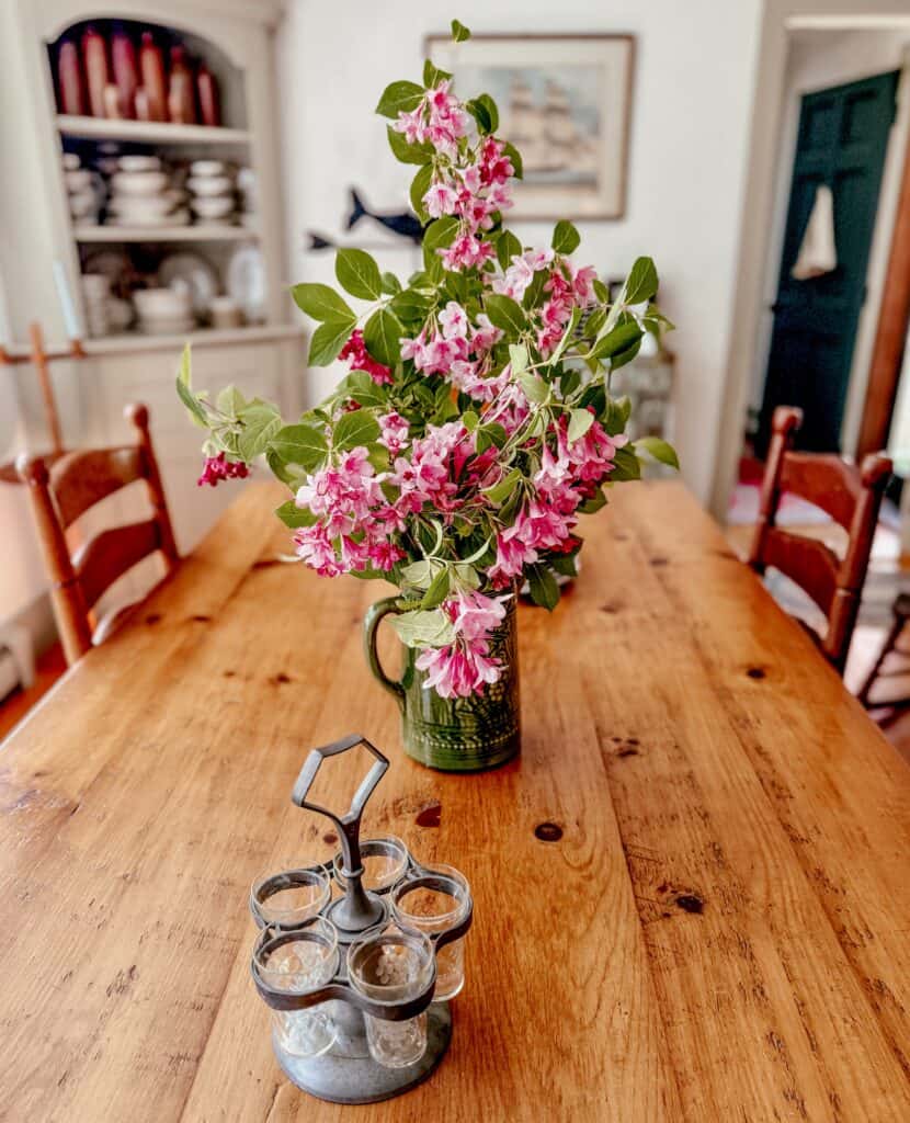 Pink flowers on wooden table.