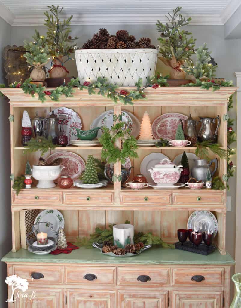 Christmas decorated hutch with red transferware.