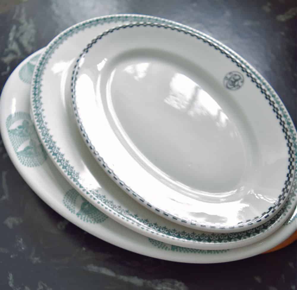 Stack of vintage hotelware dishes.