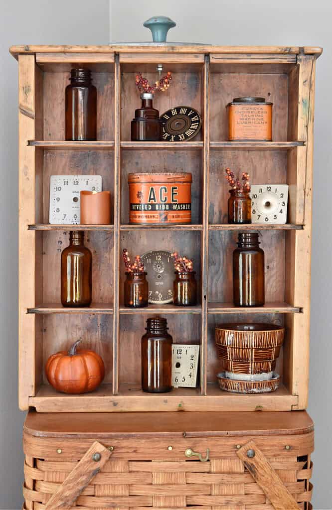 Divided drawer display with brown bottles and vintage.