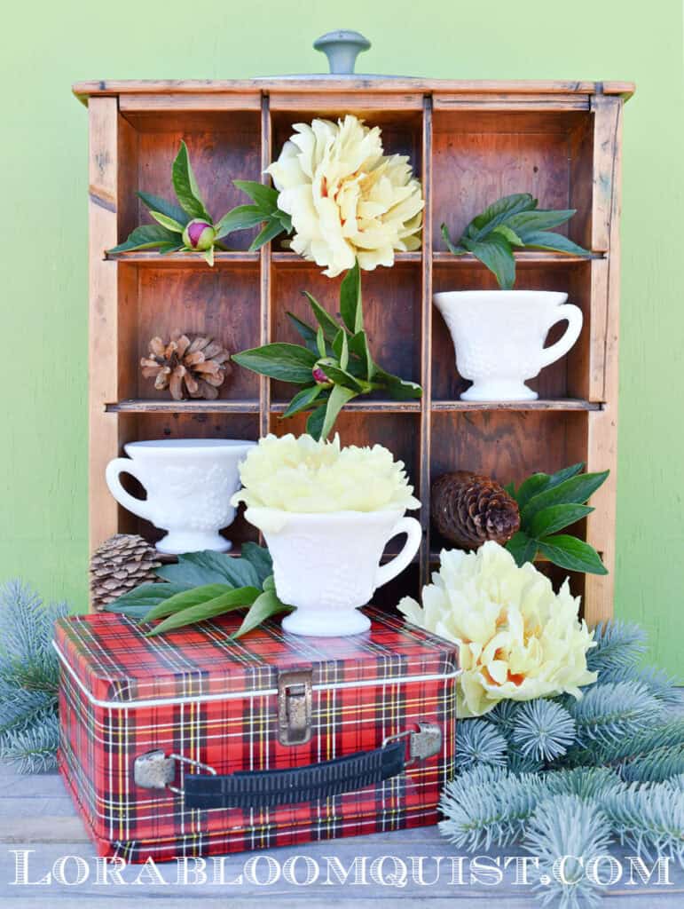 Old wooden divided drawer with peony display.