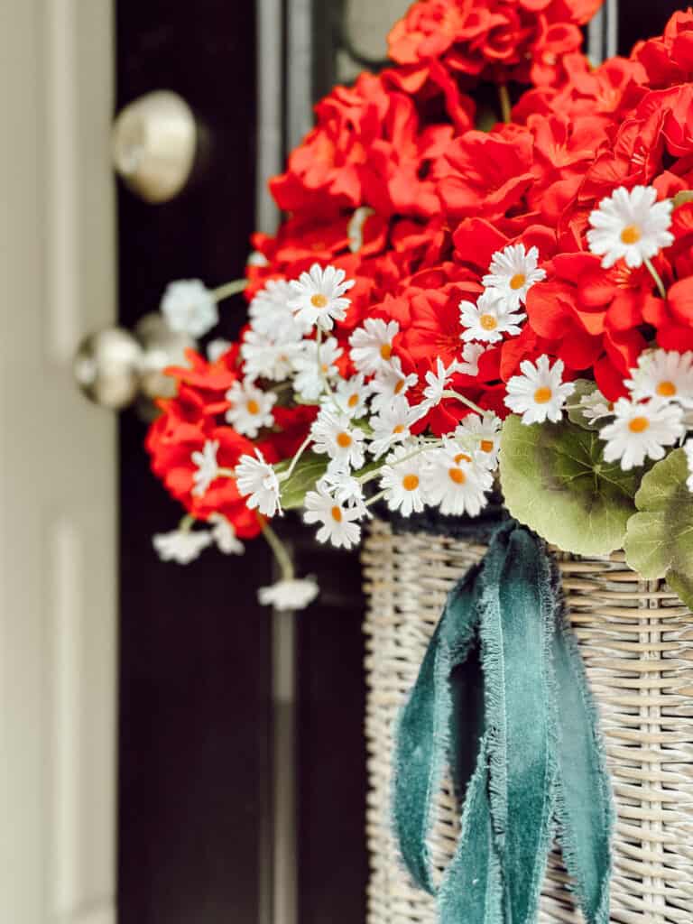 Red and white flowers in door basket