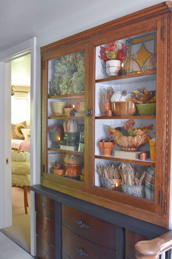 Vintage pottery fall shelf display.