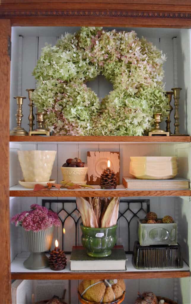 Vintage pottery fall shelf display.