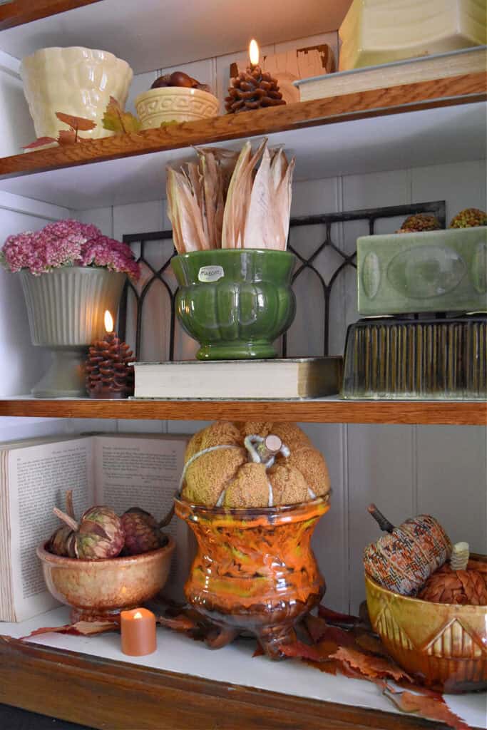 Vintage pottery fall shelf display.