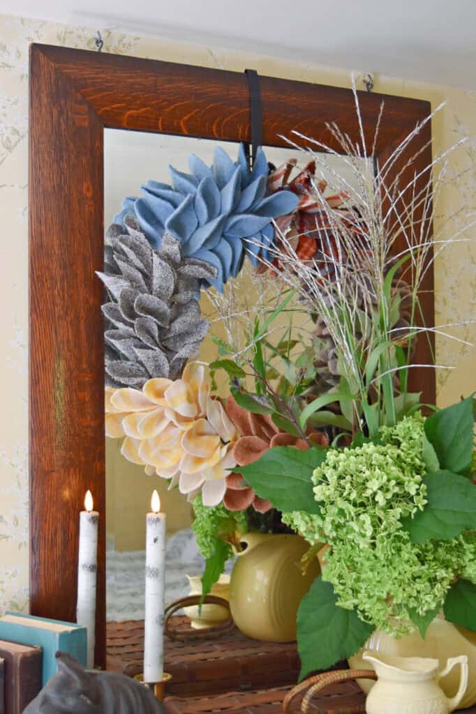 DIY fabric leaf wreath hanging on mirror.