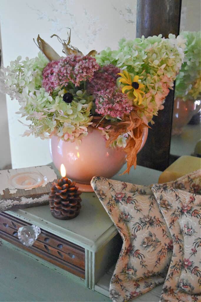 Pink luray pitcher with garden flowers.