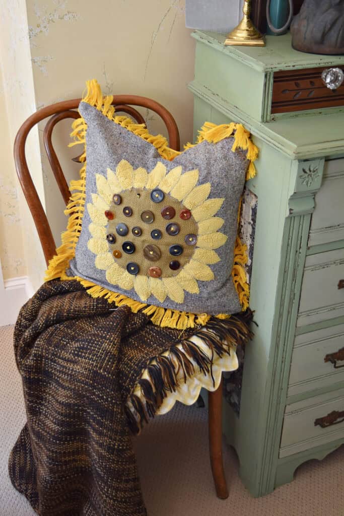 DIY sunflower button pillow on bentwood chair.
