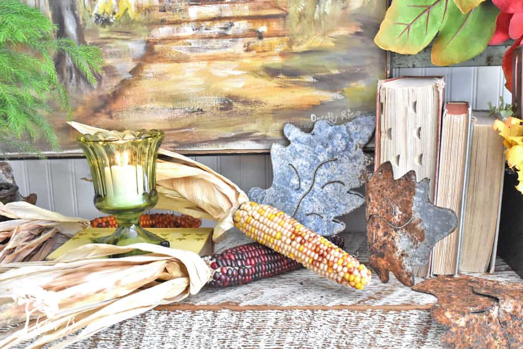 Natural decorative corn adds a rustic touch to a Fall mantel display.