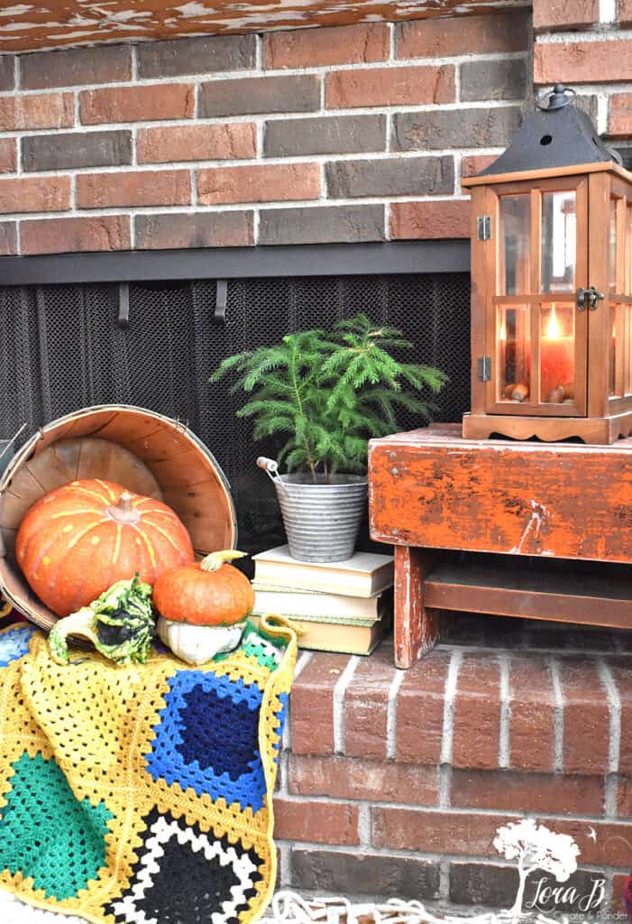 Vintage boho afghans provide softness for a decorated Fall mantel display.