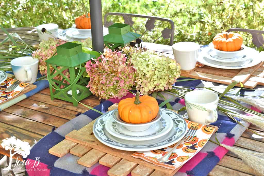 Vintage dishes set a table on a Fall decorated Porch and Patio with Salvaged Style