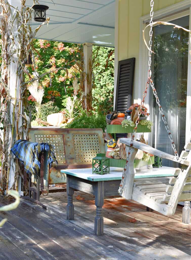 Cozy porch seating area with Fall decor.