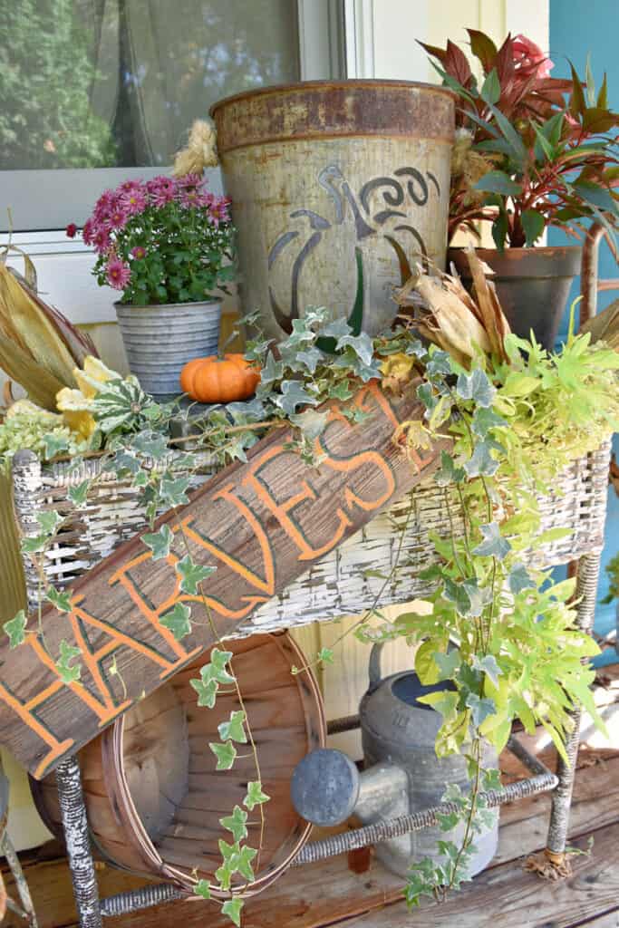 Old wicker planter with Fall porch decor.